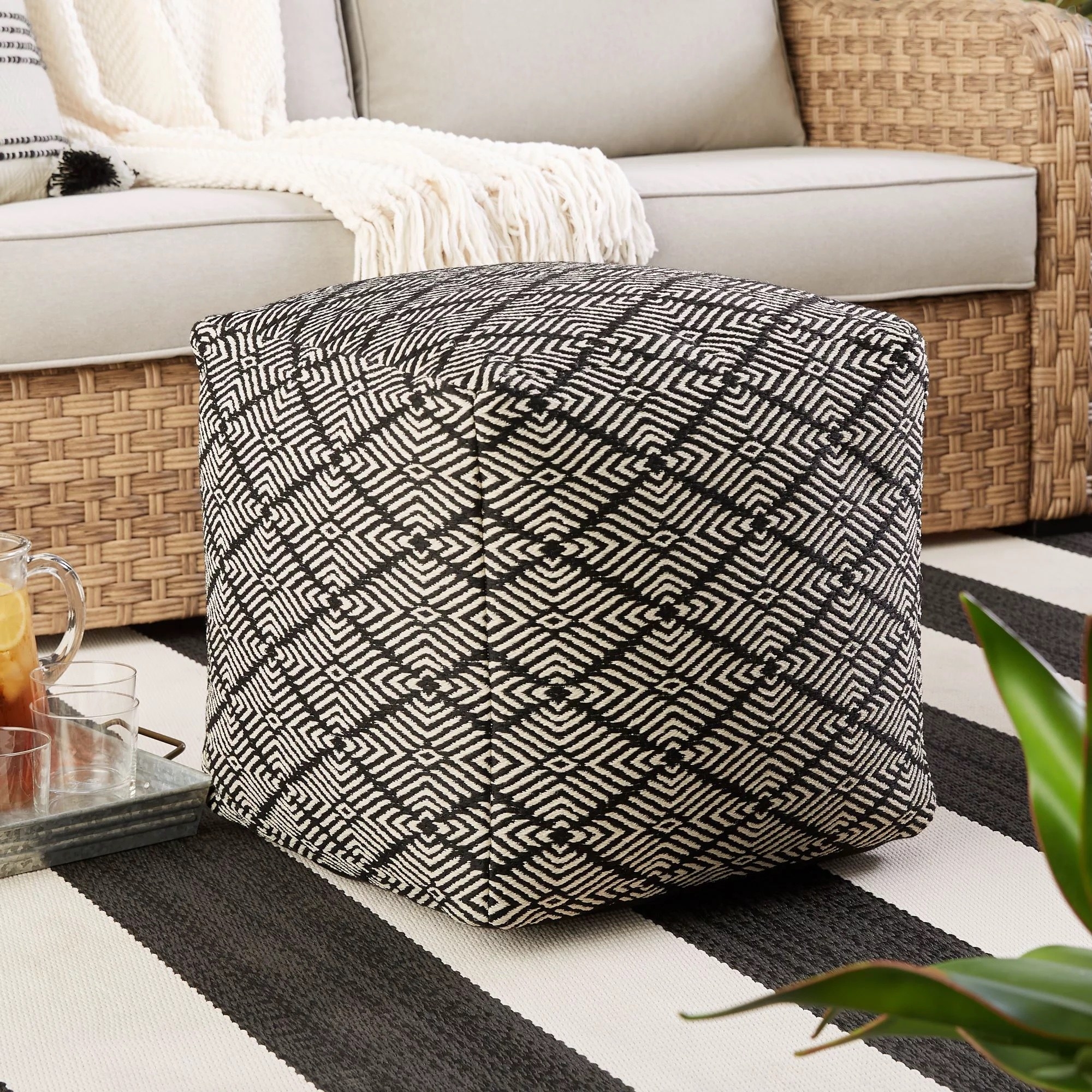 black and white square pouf on the floor