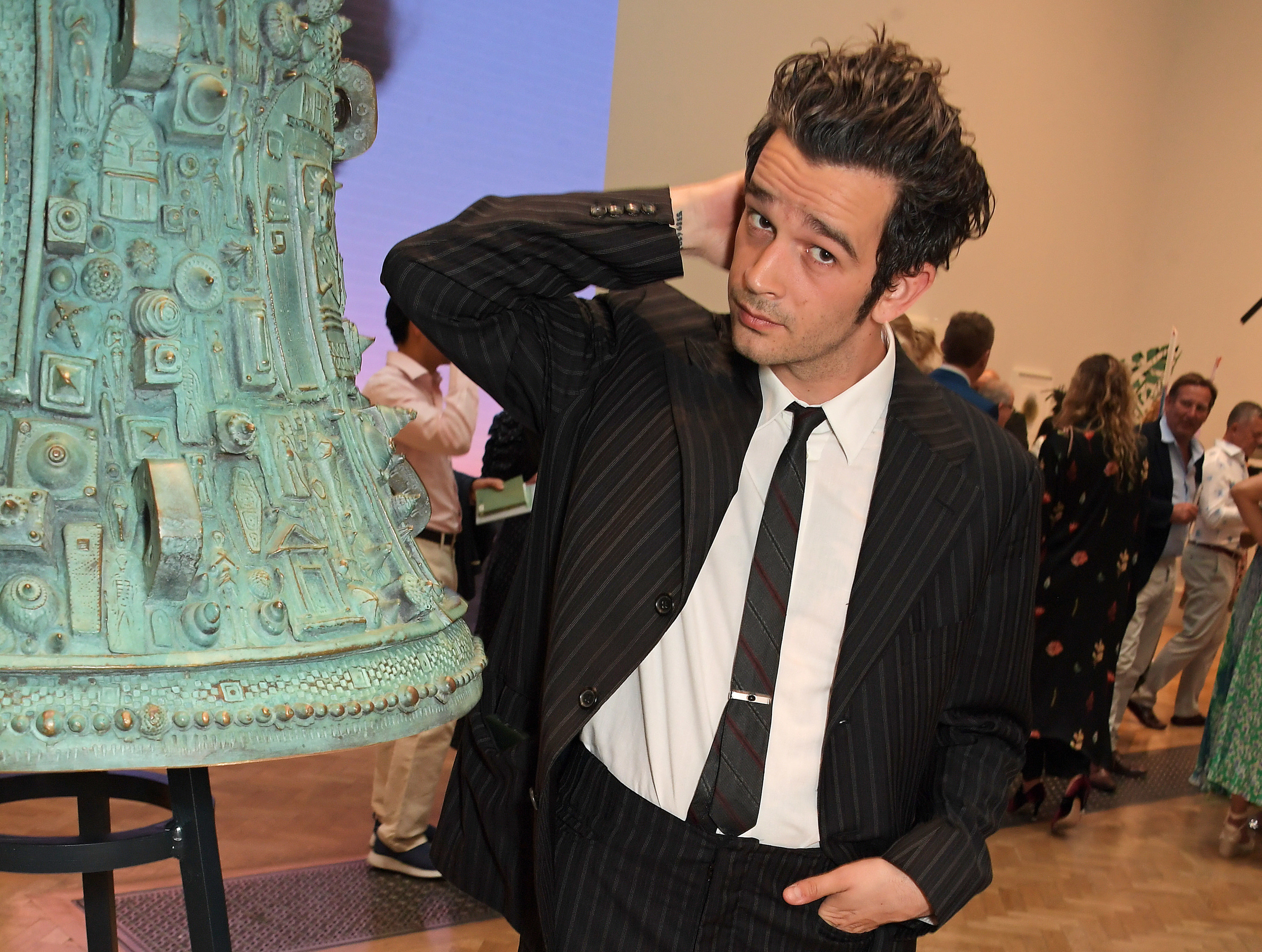 Matty in a suit and tie at an event