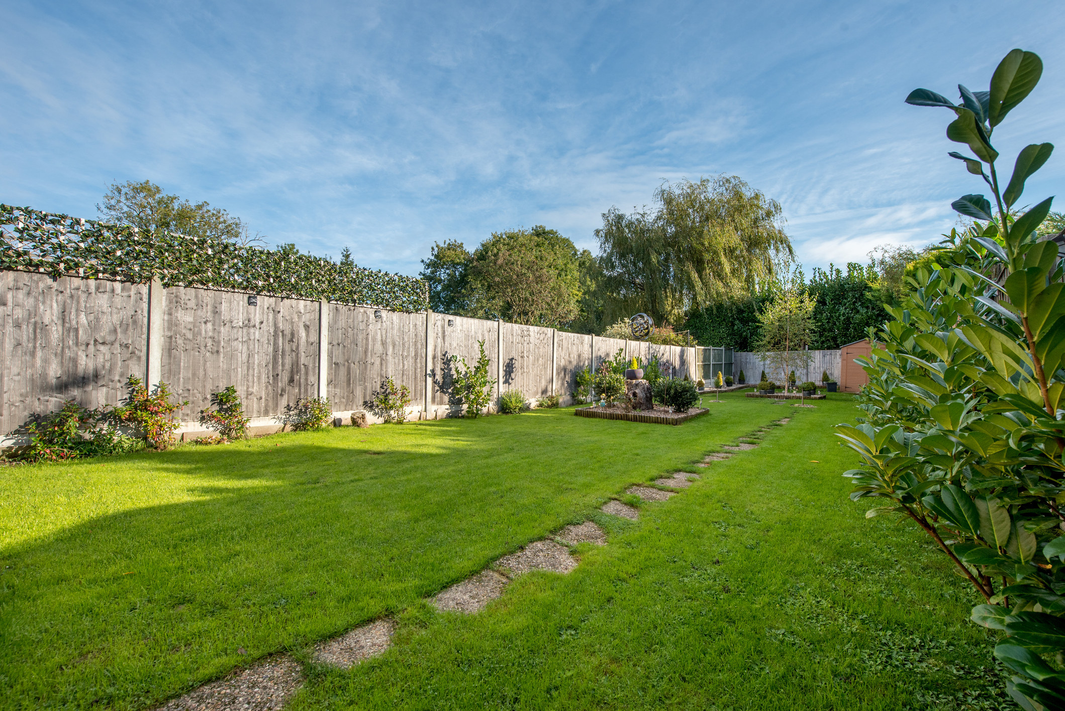 A fenced in back yard with a garden