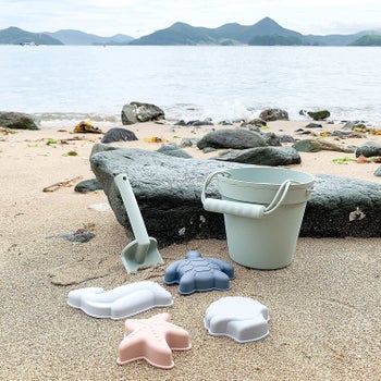 Silicone beach bucket, sand molds, and shovel in muted colors