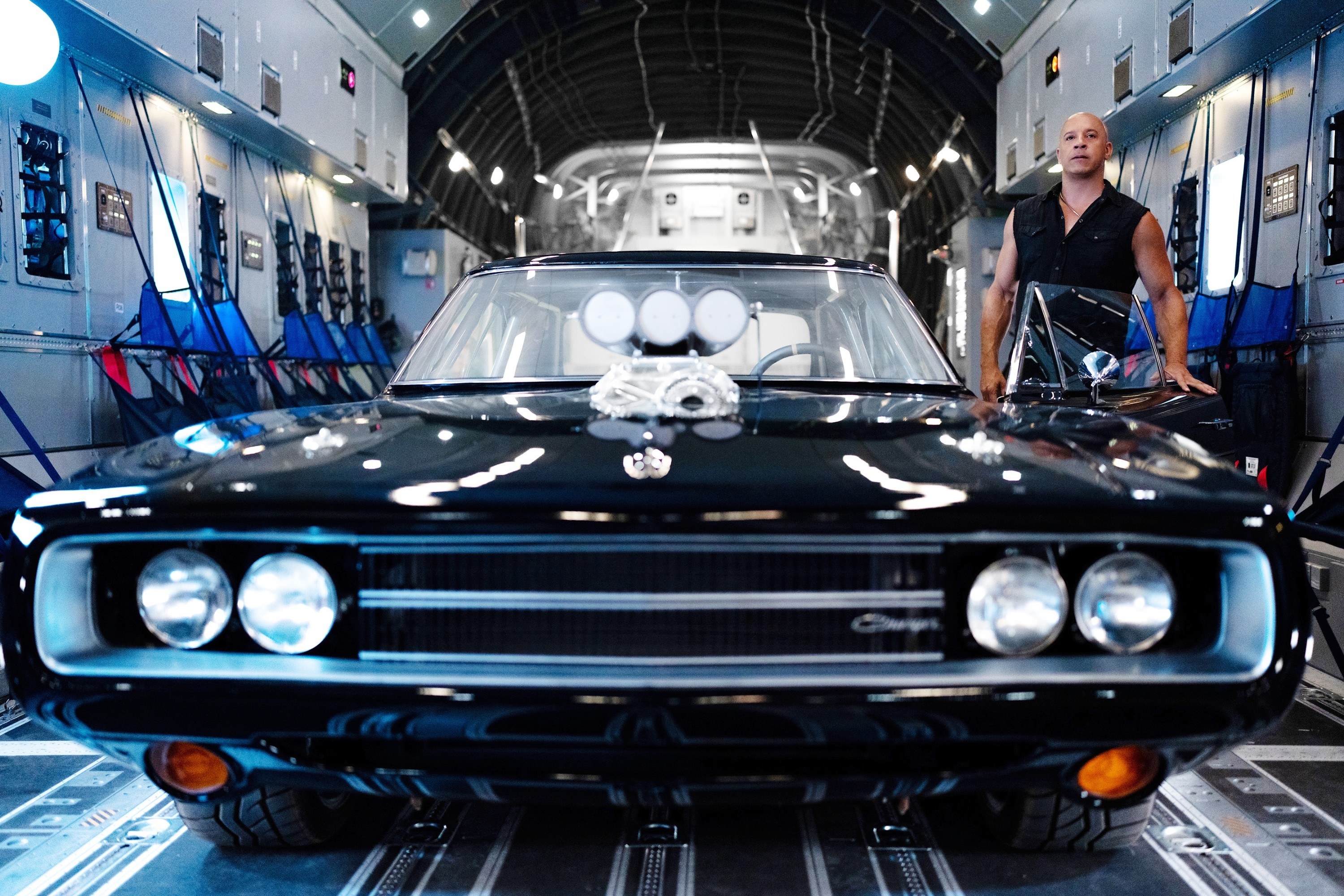 A man stands beside a car