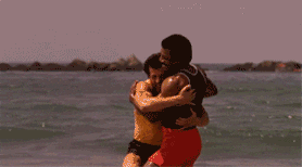 GIF of Rocky and Apollo Creed celebrating on the beach in Rocky III