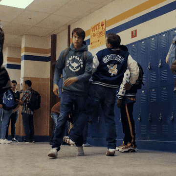 A bully tripping a boy in the hallway of a high school