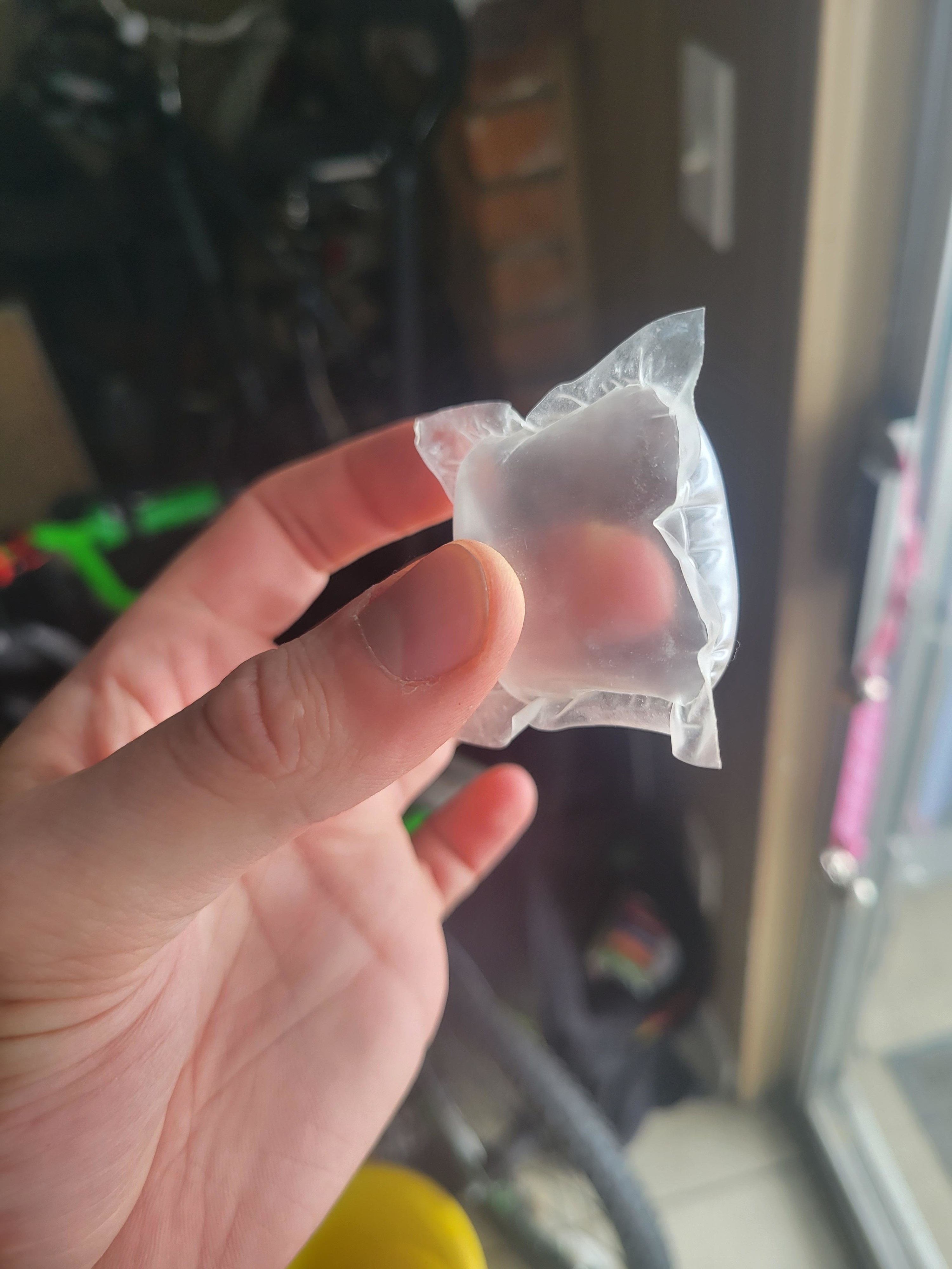 a plastic laundry pod that is empty inside, just filled with air