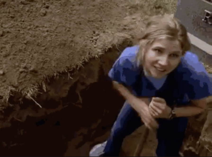 A nurse digging a hole