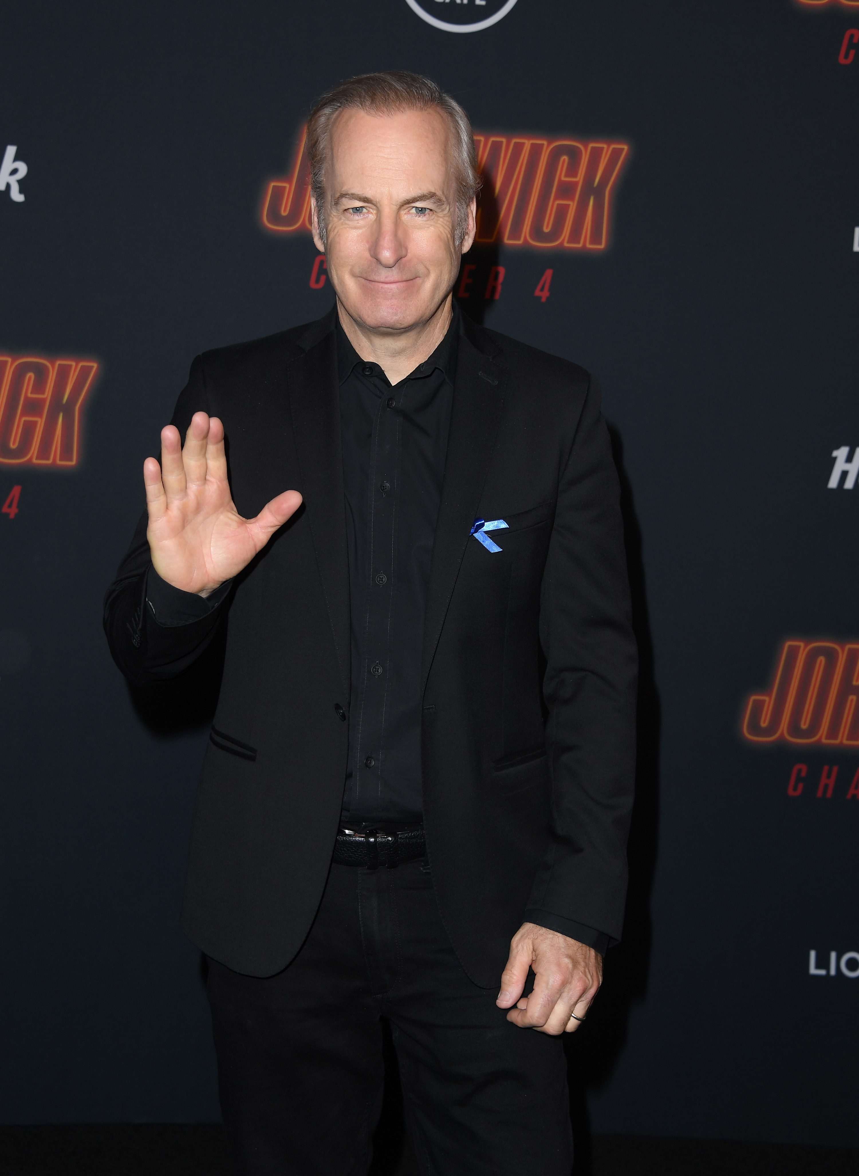 bob odenkirk poses on a red carpet