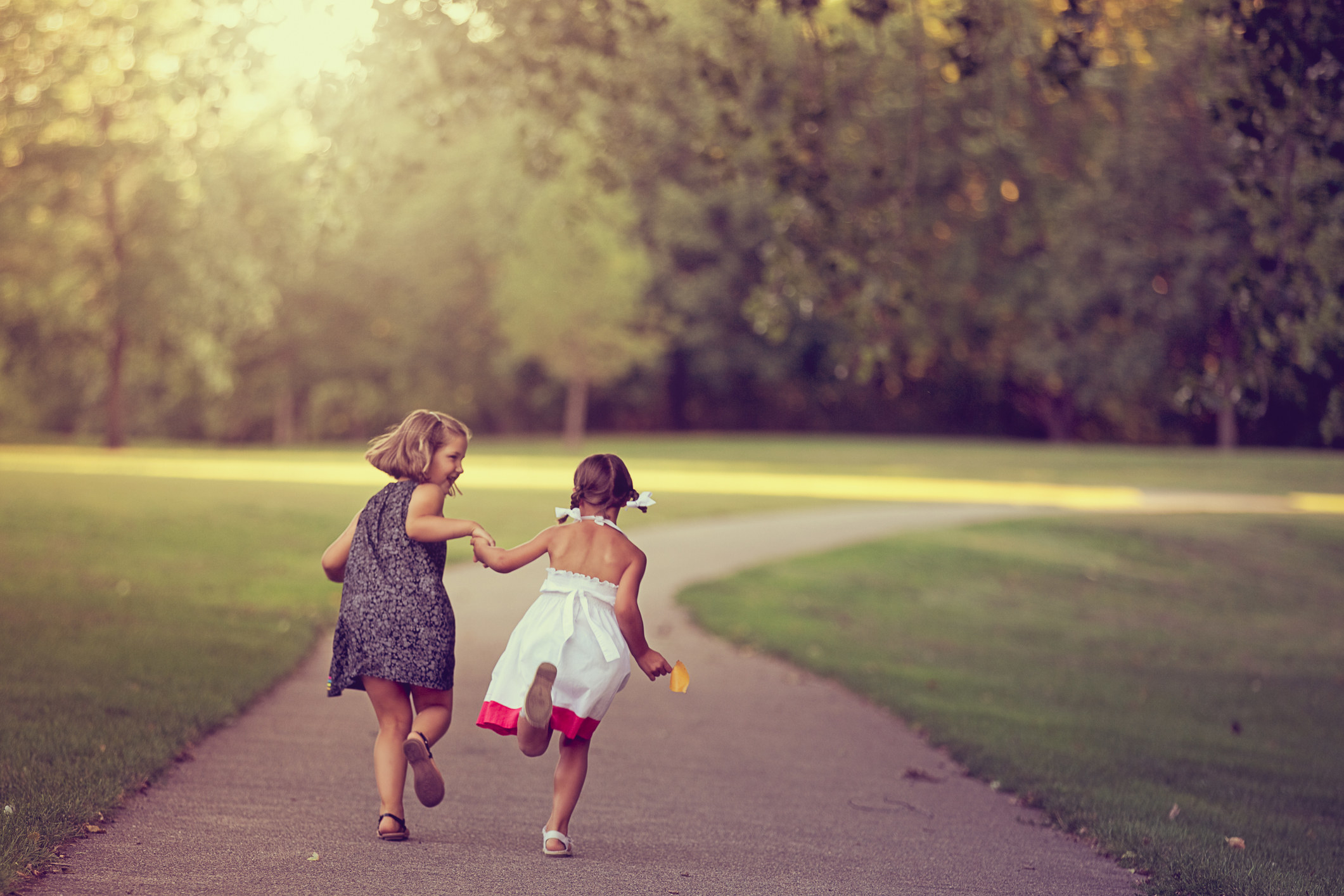 Kids running down a sidewalk
