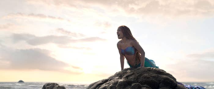 Halle as Ariel singing on a rock in the movie