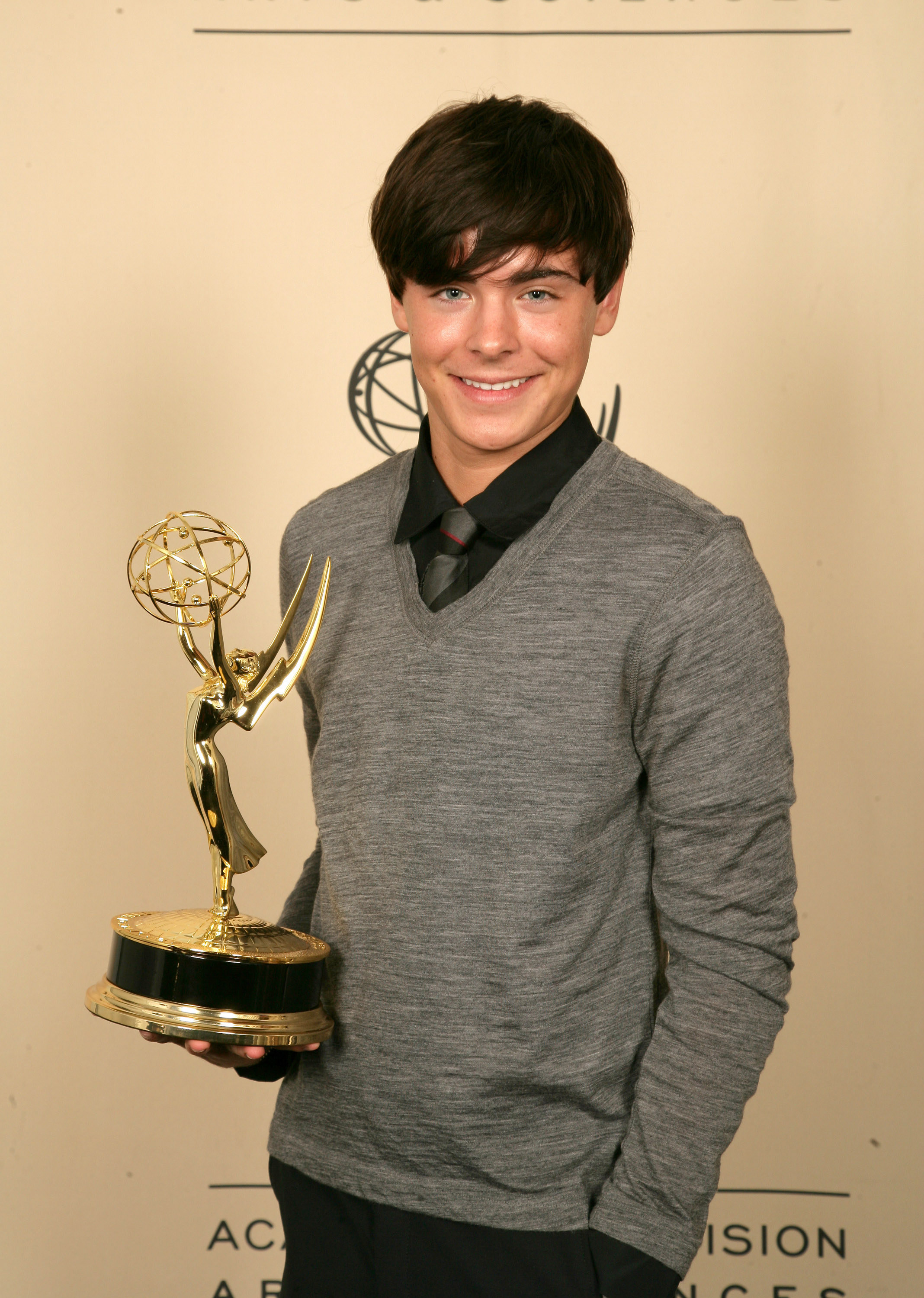 holding an award with long hair