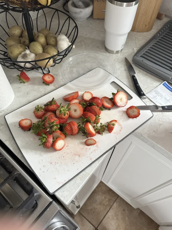 a chunk of the strawberry still there with the stem