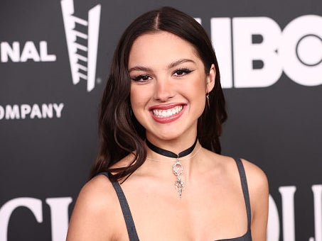Singer-actress Olivia Rodrigo smiling at a red carpet event