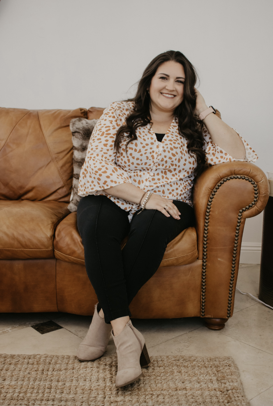 a woman posing while sitting on a couch