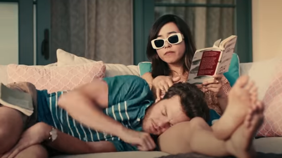 A woman gives a sleeping man a wet willy