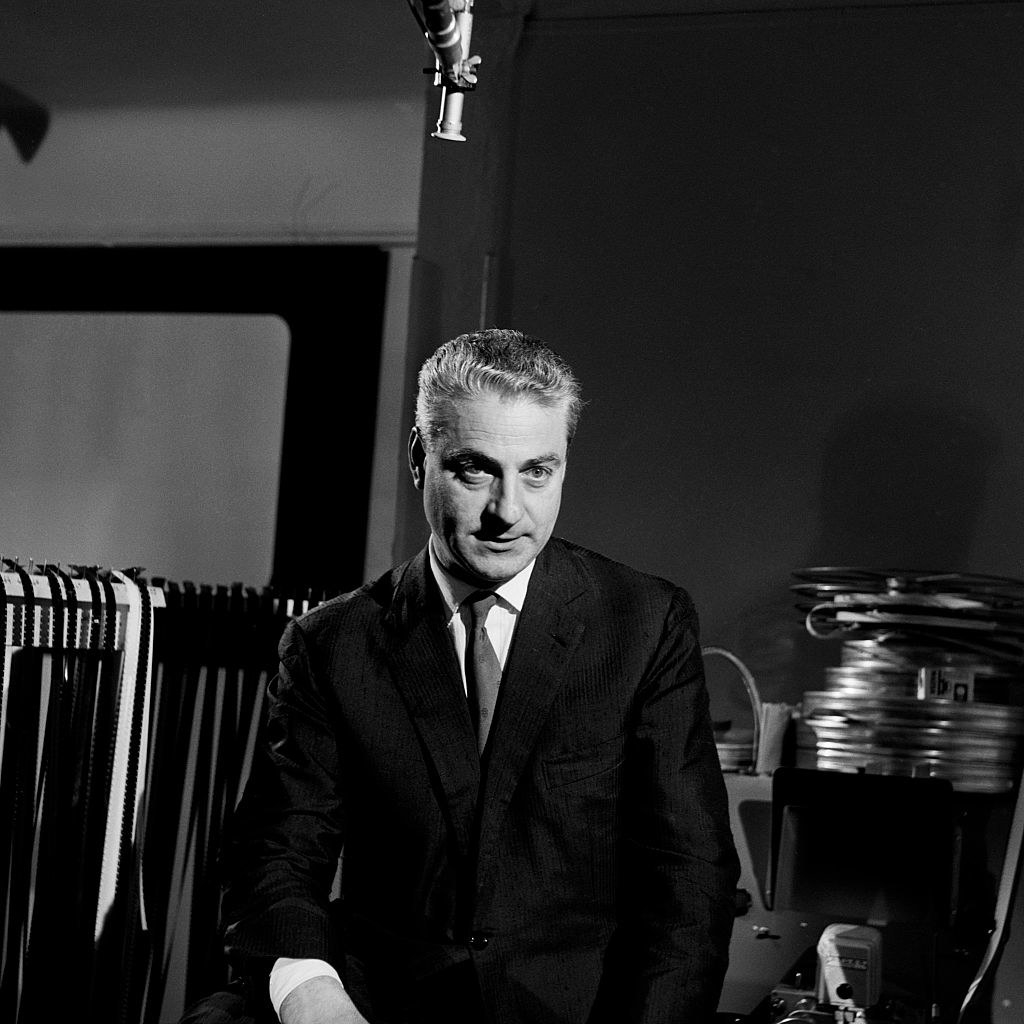 A closeup of René Clément in a suit and tie