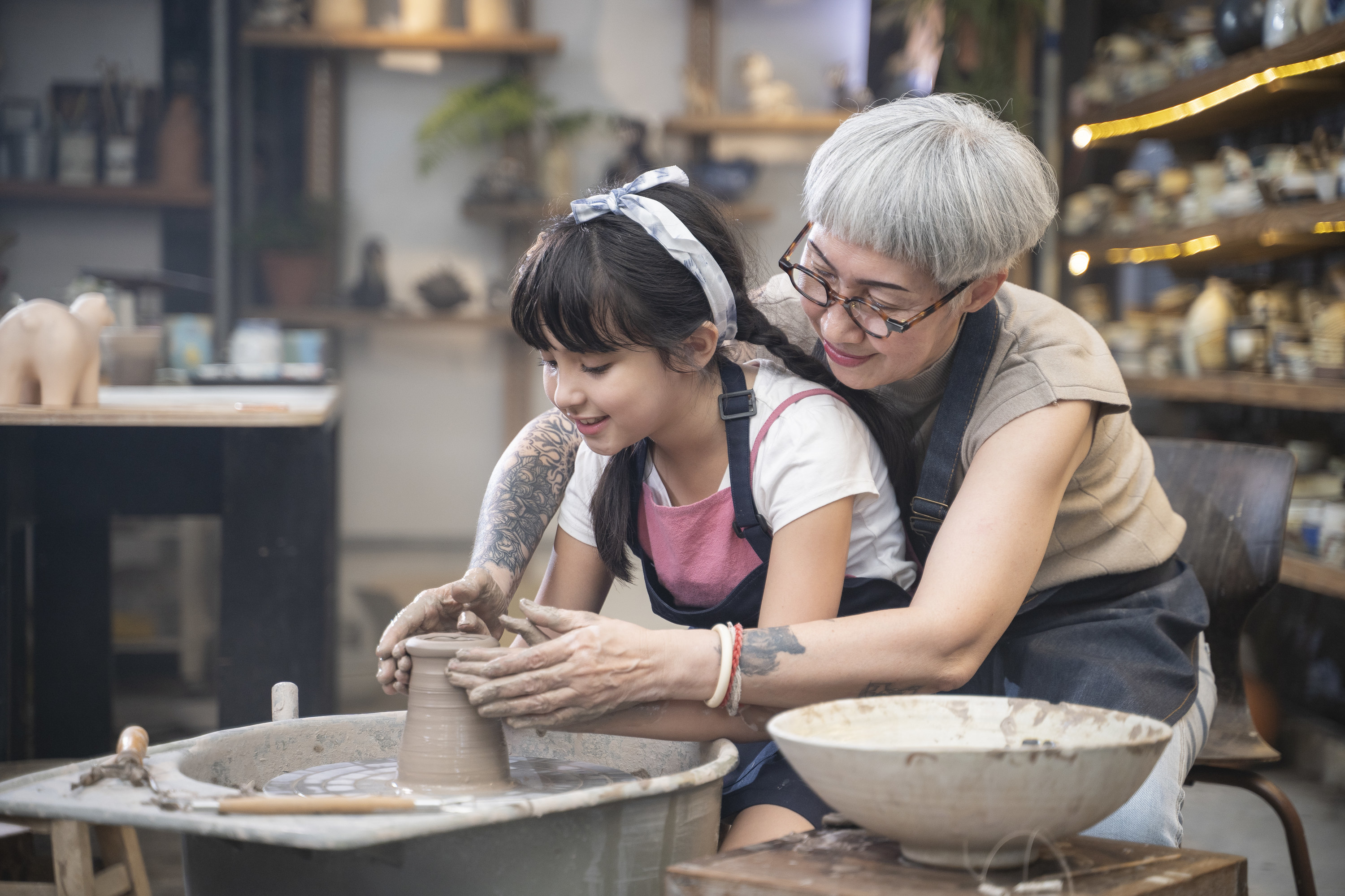 a mom and daughter doing pottery