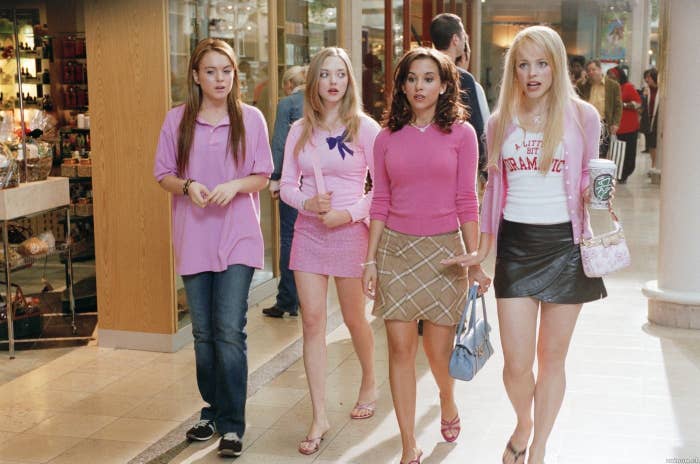 From left to right: Lindsay Lohan, Amanda Seyfried, Lacy Chabert, and Rachel McAdams walking through a mall in a scene from Mean Girls