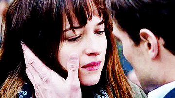 Dakota Johnson and Jamie Dornan in the 50 Shades Franchise staring at each other while openly panting.
