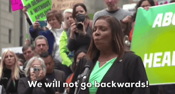 Woman speaking at a women's rights rally saying &quot;We will not go backwards&quot;