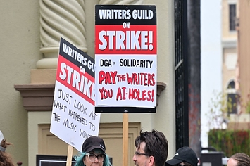 Writers hold signs while picketing in front of Paramount Studios in Los Angeles, California on May 15, 2023