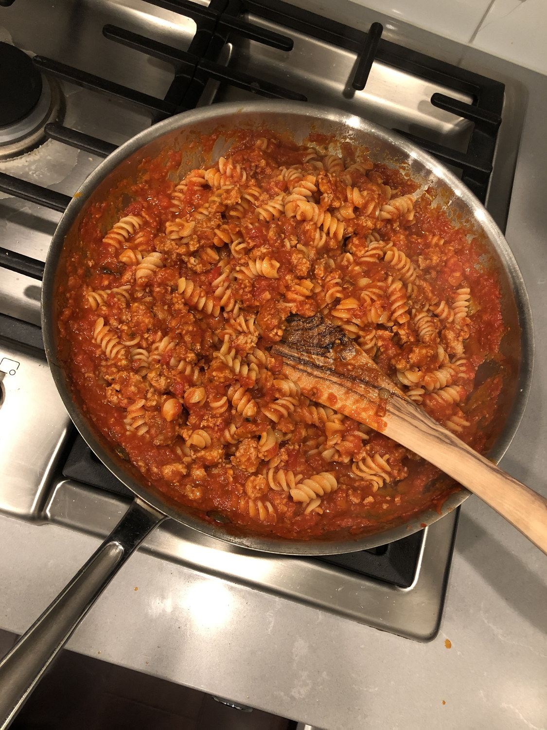 Fusilli in tomato sauce simmering.