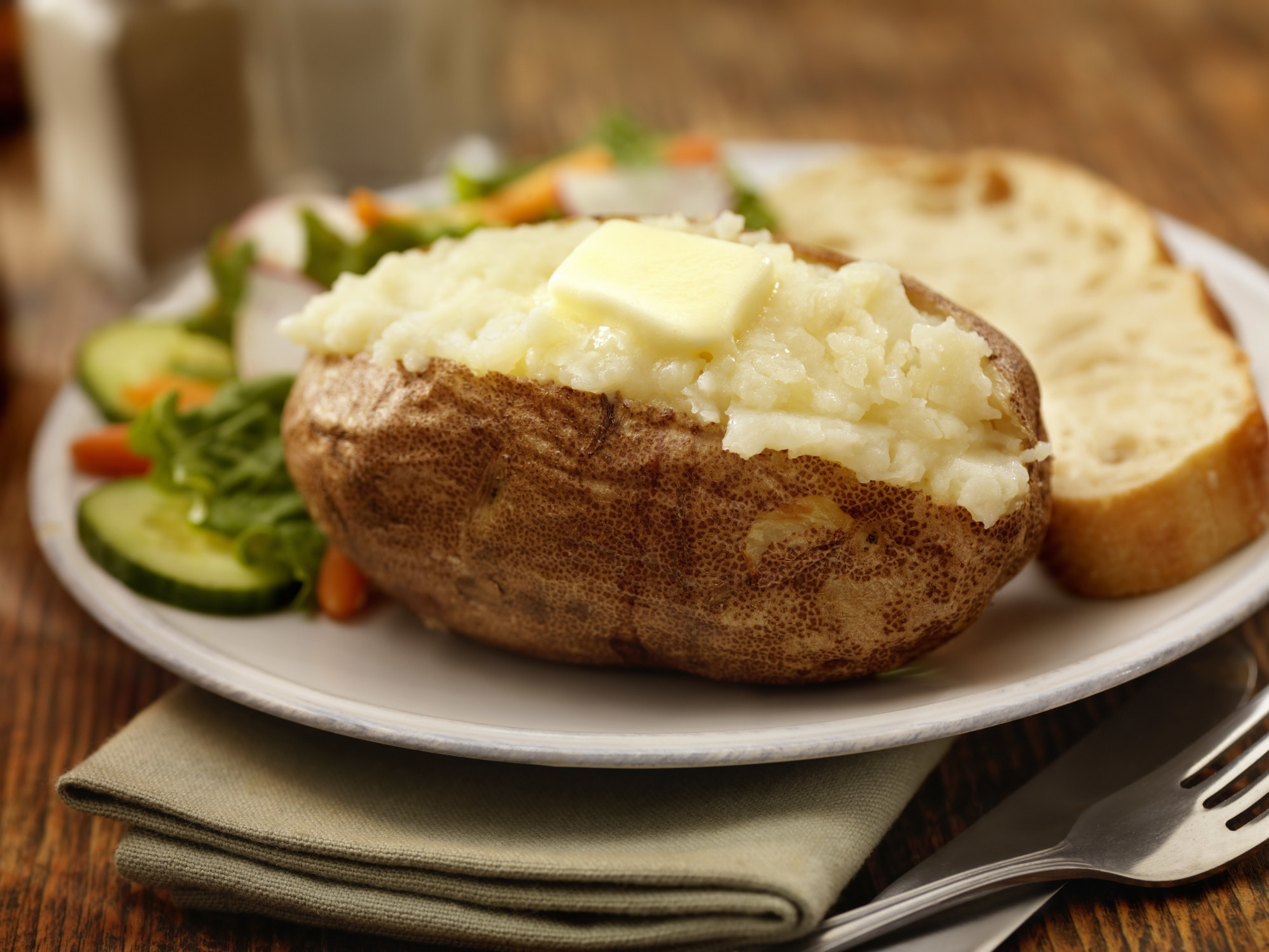 A baked potato with butter.