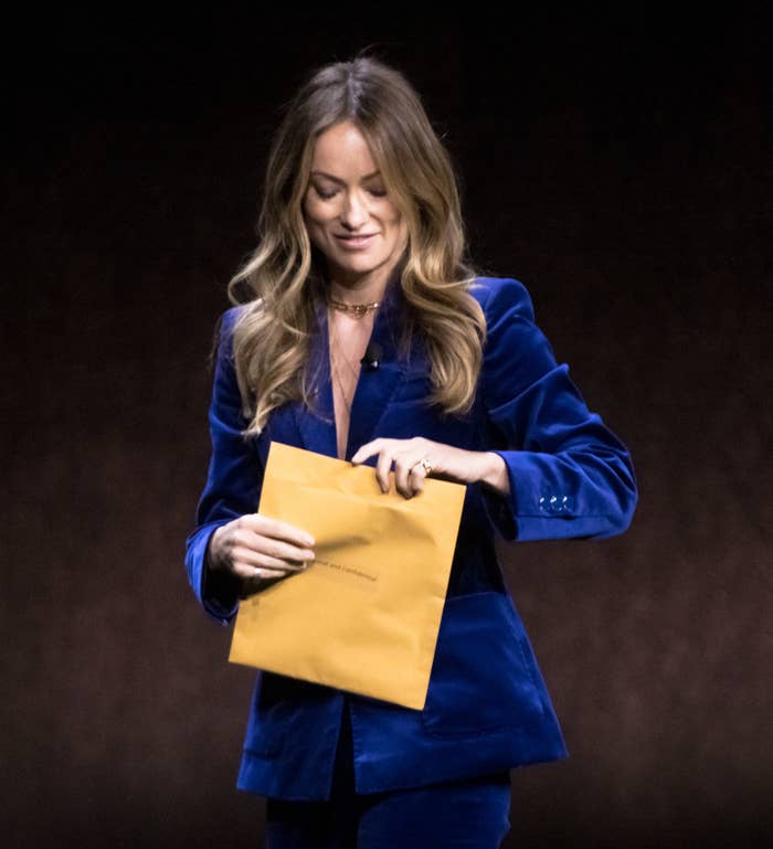 olivia opening an envelope on stage