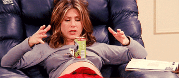 Jennifer Aniston balancing a soda can on her pregnant stomach.