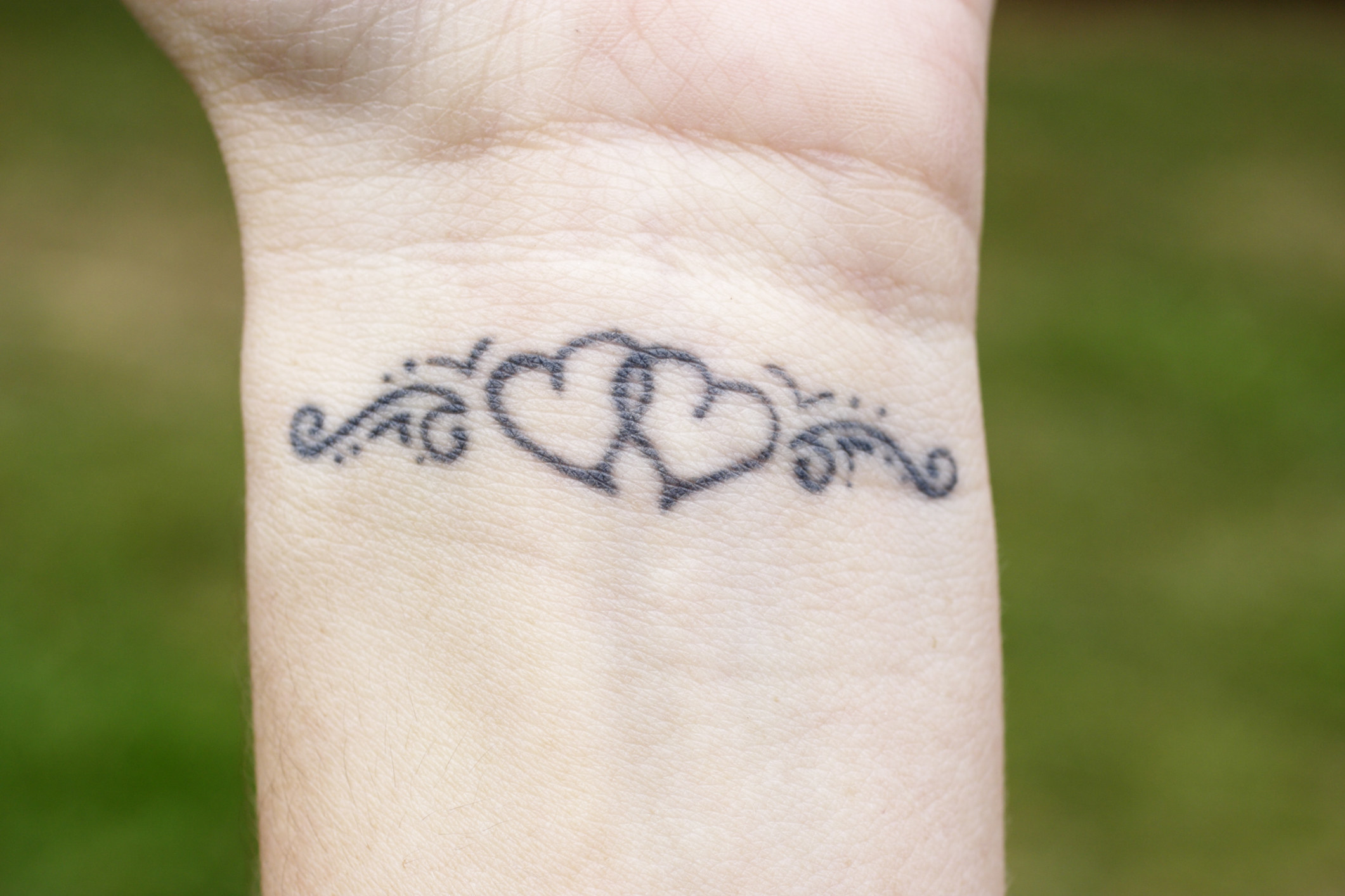 A heart tattoo on a wrist.