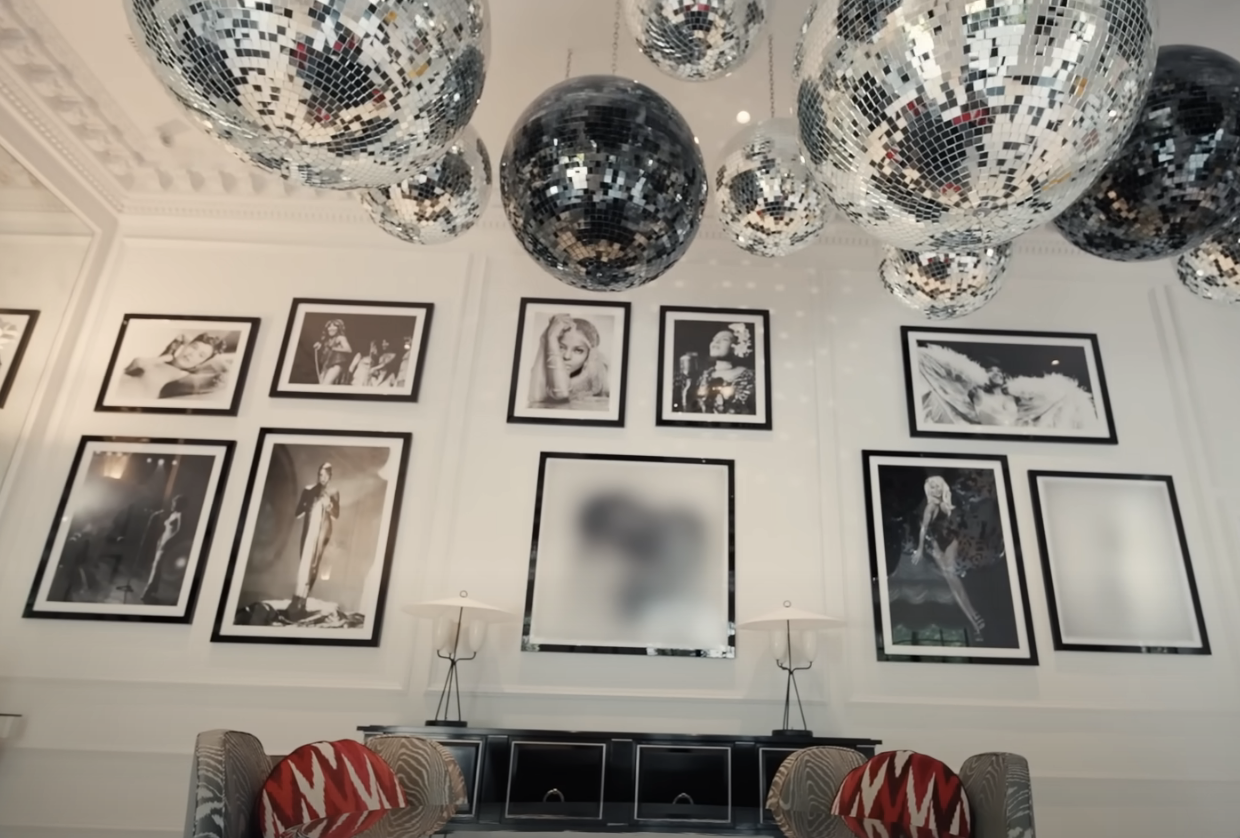 Disco ball hanging from the ceiling and photographs of disco artists on the wall