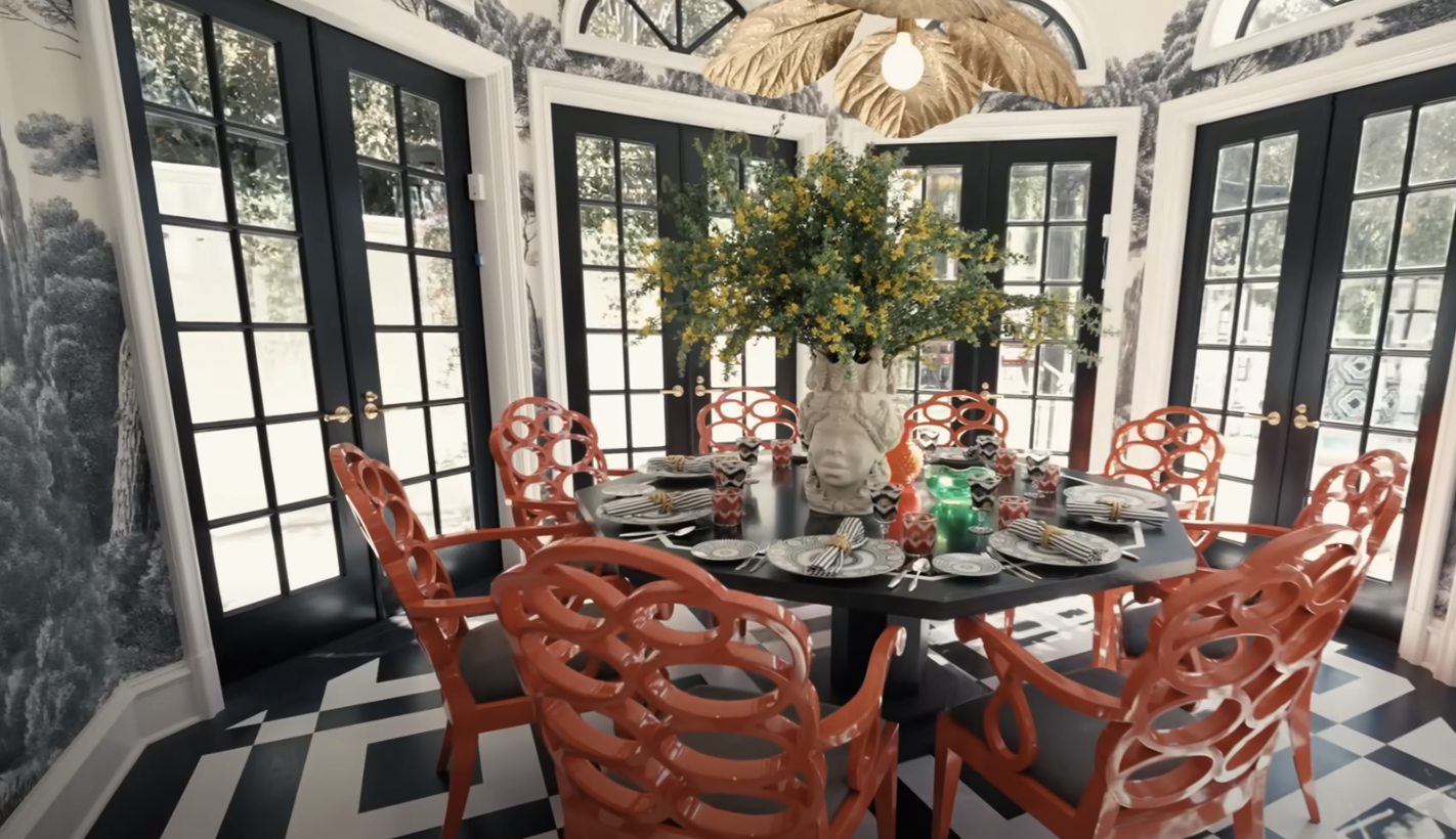 breakfast nook off the kitchen with bright orange chairs surrounding a table