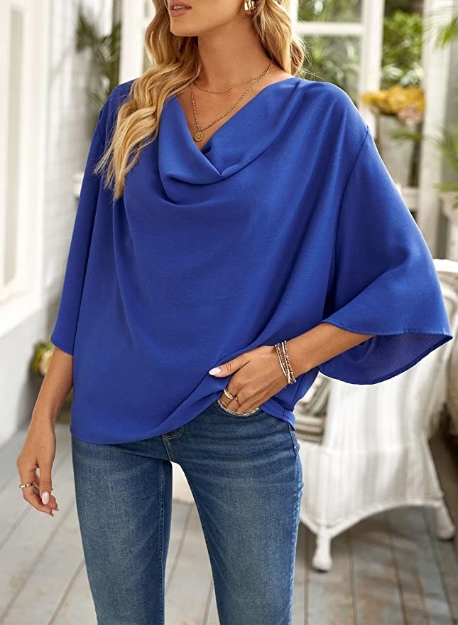 The model in blue 3/4 cap sleeve blouse