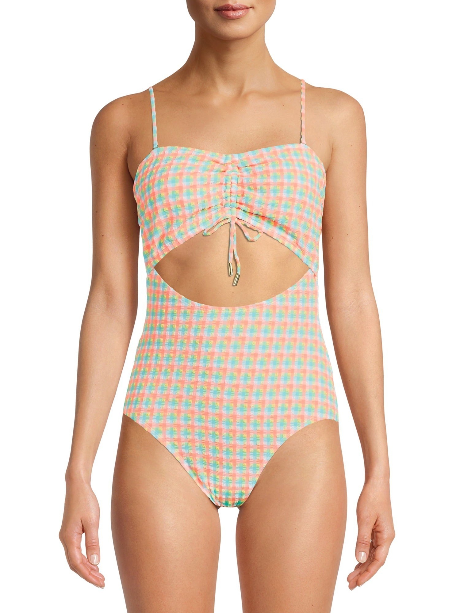 Model wearing blue and orange checkered cutout one-piece bathing suit