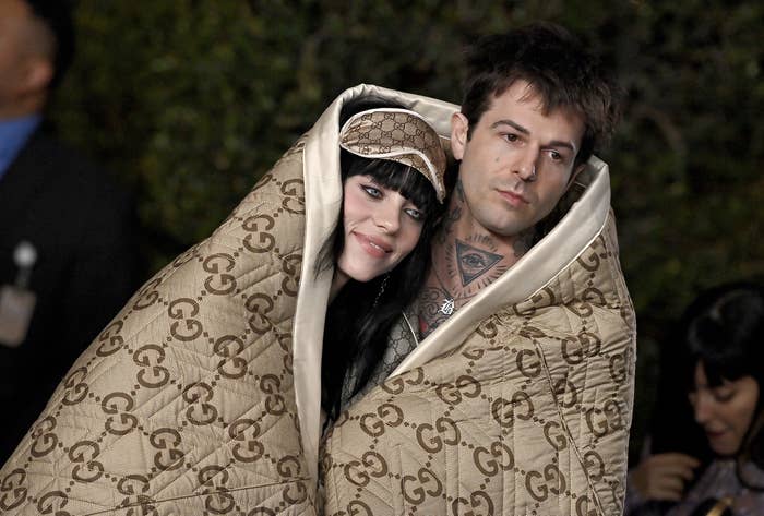 the pair with a large Gucci blanket over them