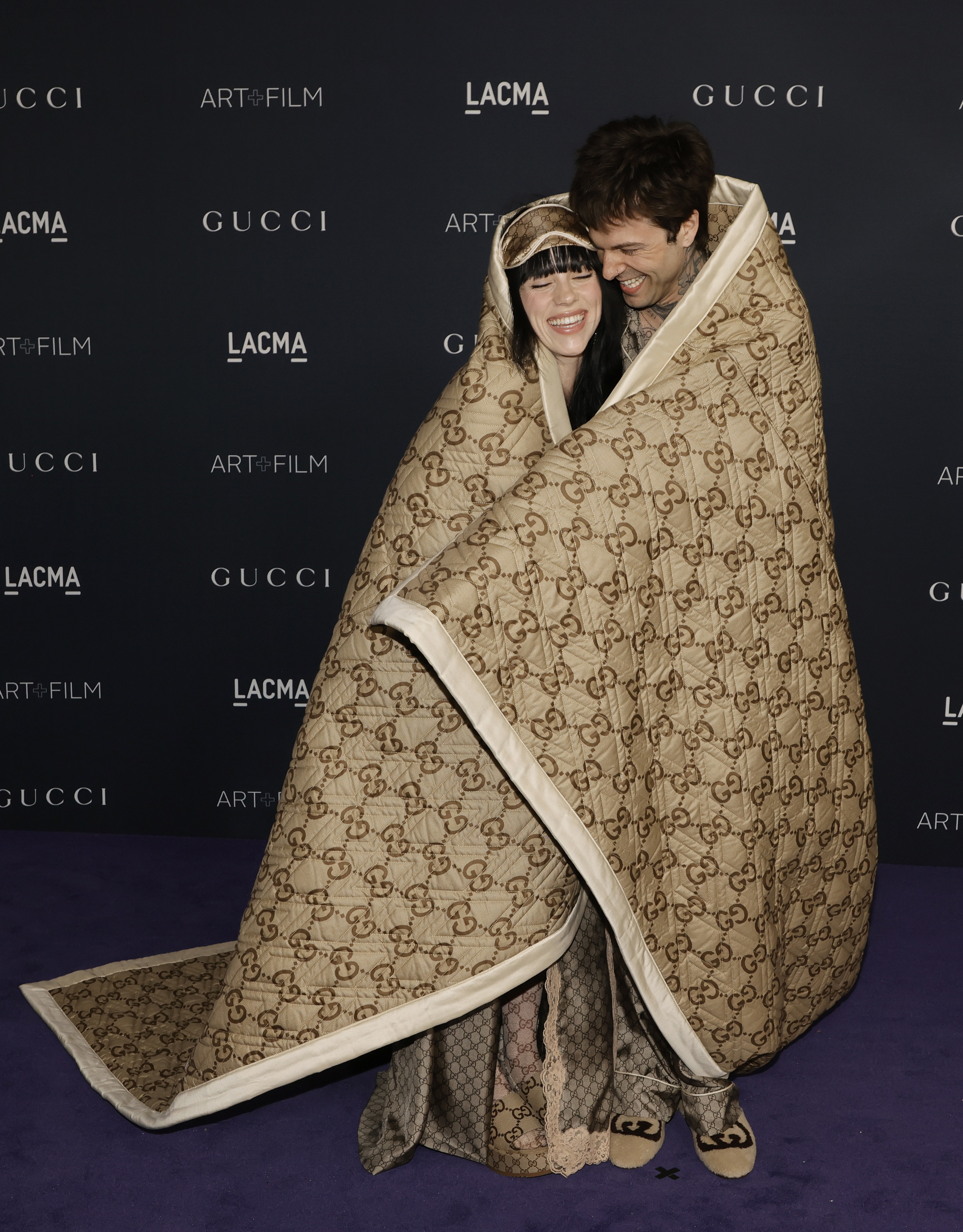 the two at an event wrapped in a large blanket
