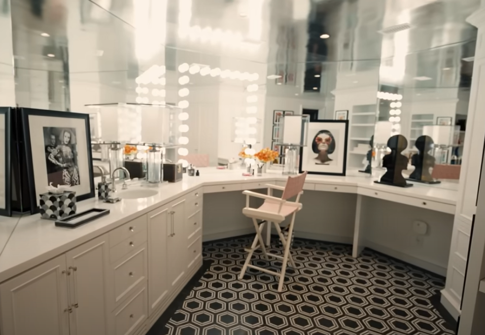 the glam room in RuPaul&#x27;s home, with a makeup chair, mirrored walls, and tile floor