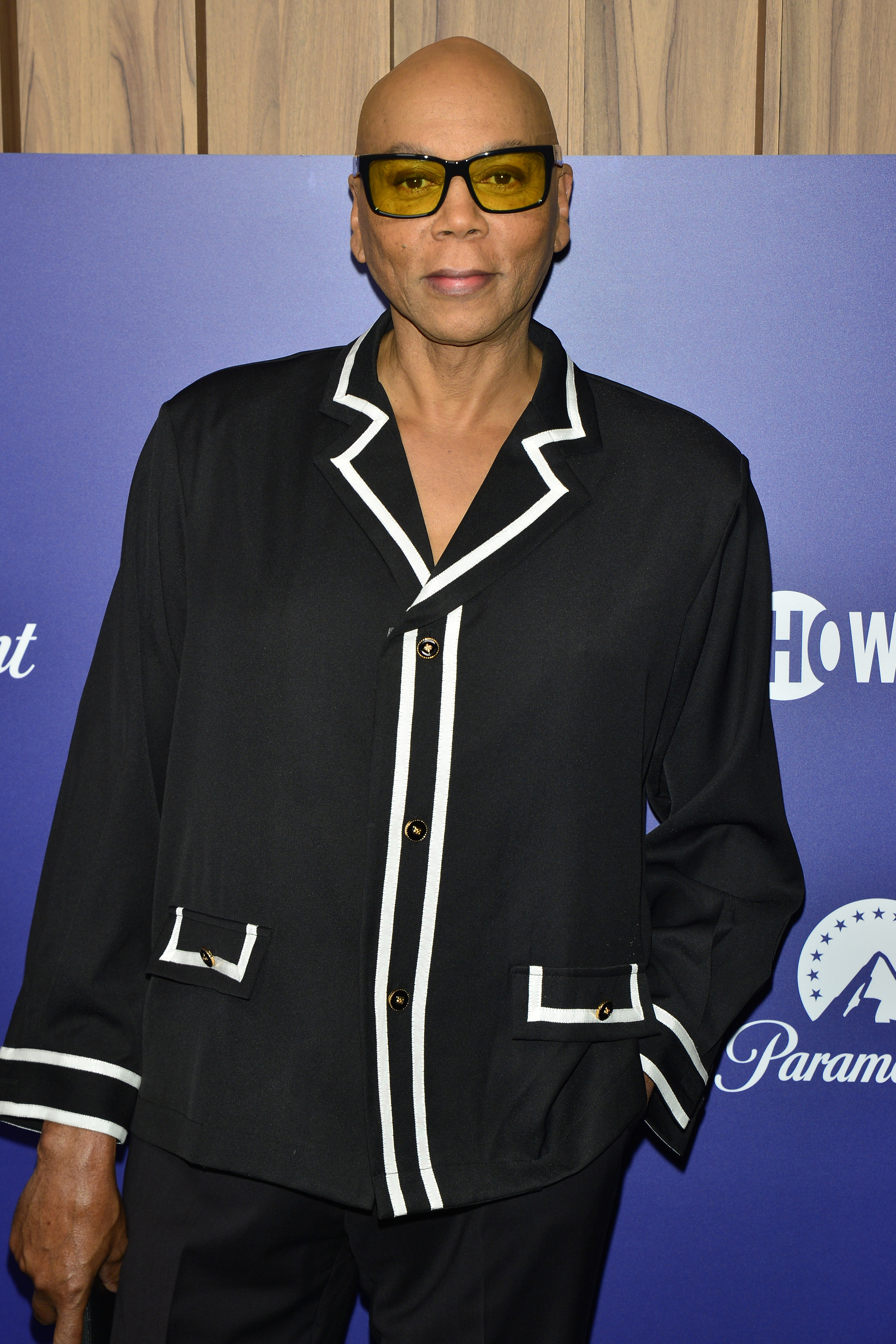 RuPaul in front of a step and repeat