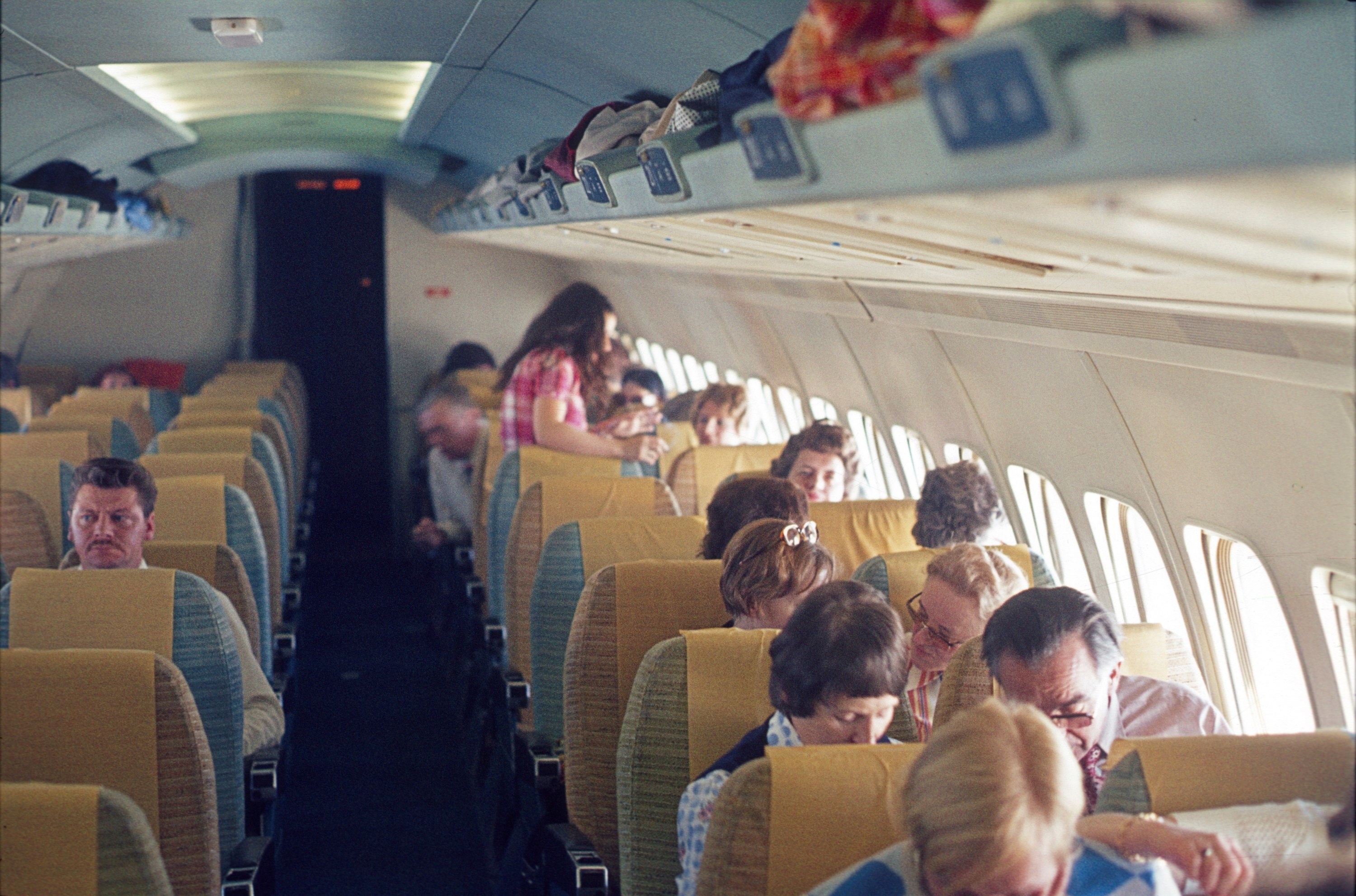 Plane passengers sit during a flight in 1972