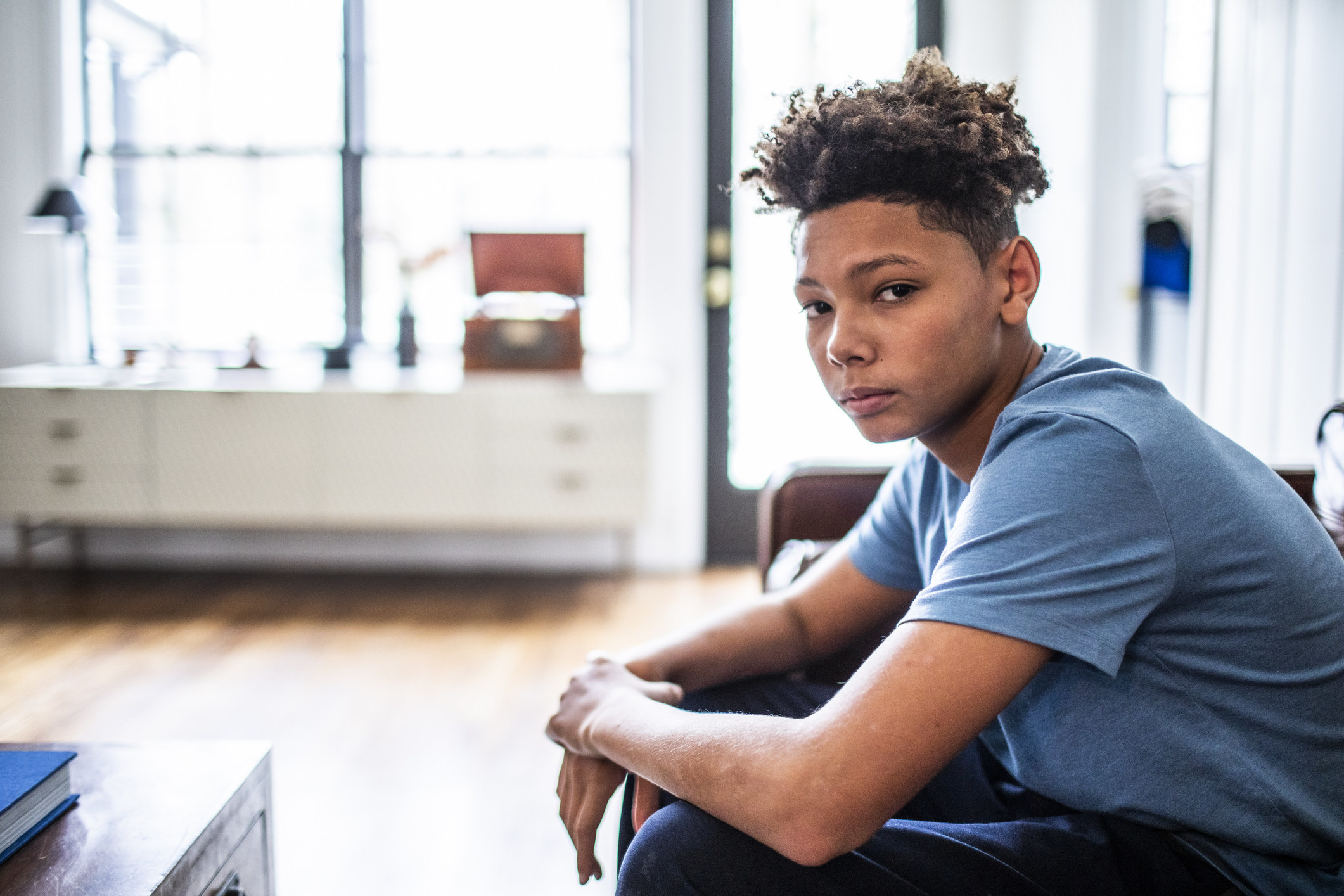 Upset male teen sitting on a couch