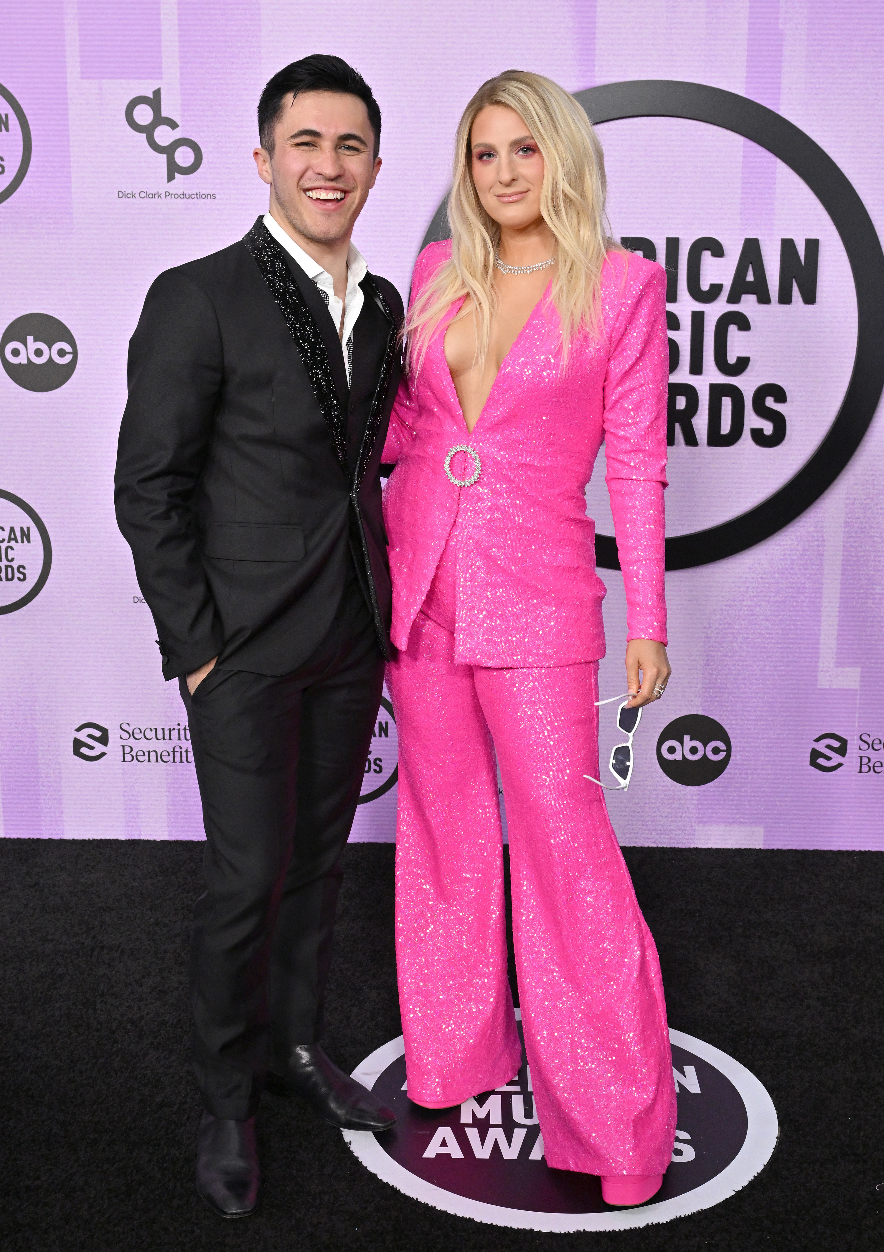 Chris Olsen poses on the red carpet for photographers with Megan Trainor
