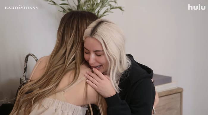 Kim being hugged as she cries