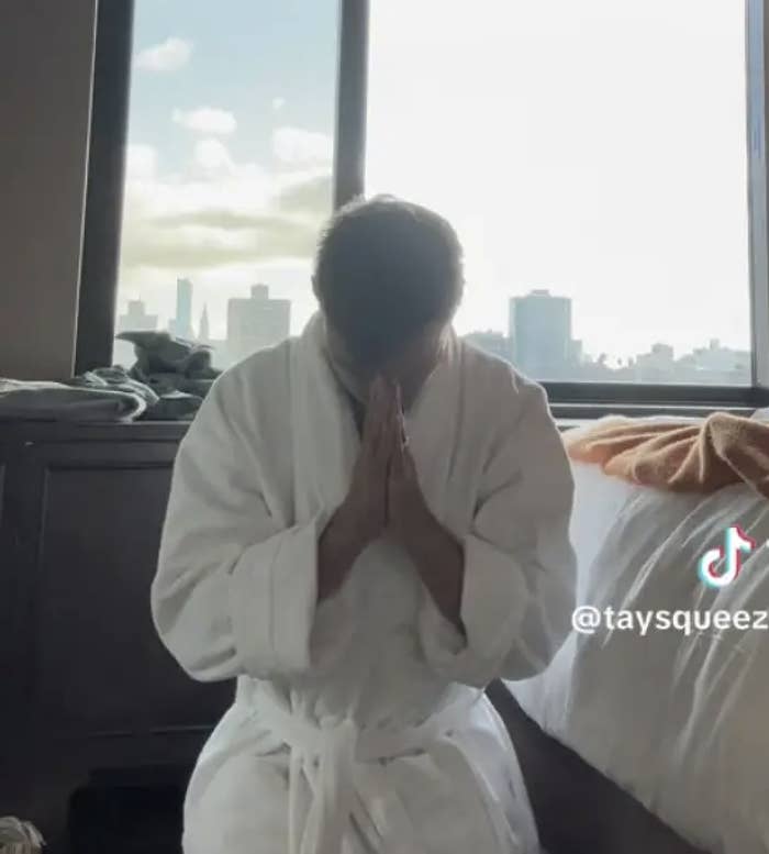 Taylor Lautner wearing a robe kneeling in prayer