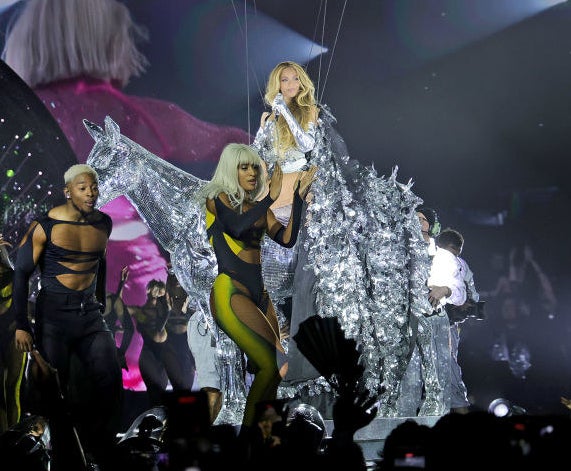 beyonce in the cape while sitting on a disco ball horse