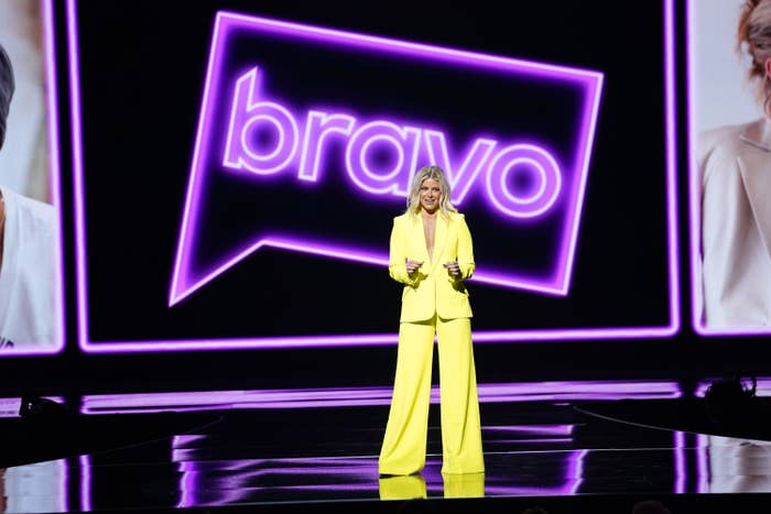 raquel leviss on stage wearing a bright pantsuit