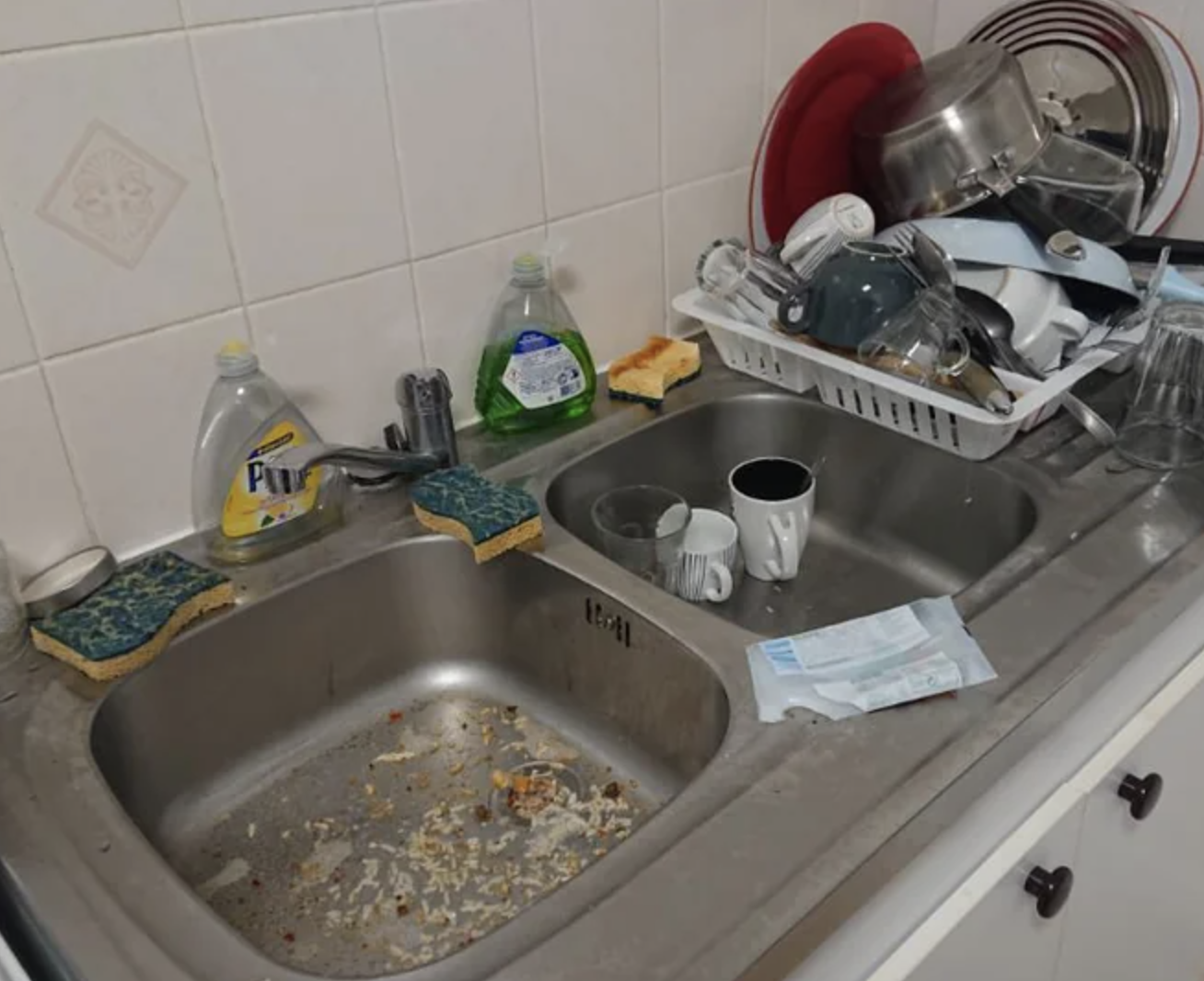 The sink is full of food, while the dishes are stacked on the counter with no rhyme or reason