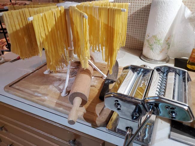 a reviewer photo of fresh made fettuccine next to the pasta maker