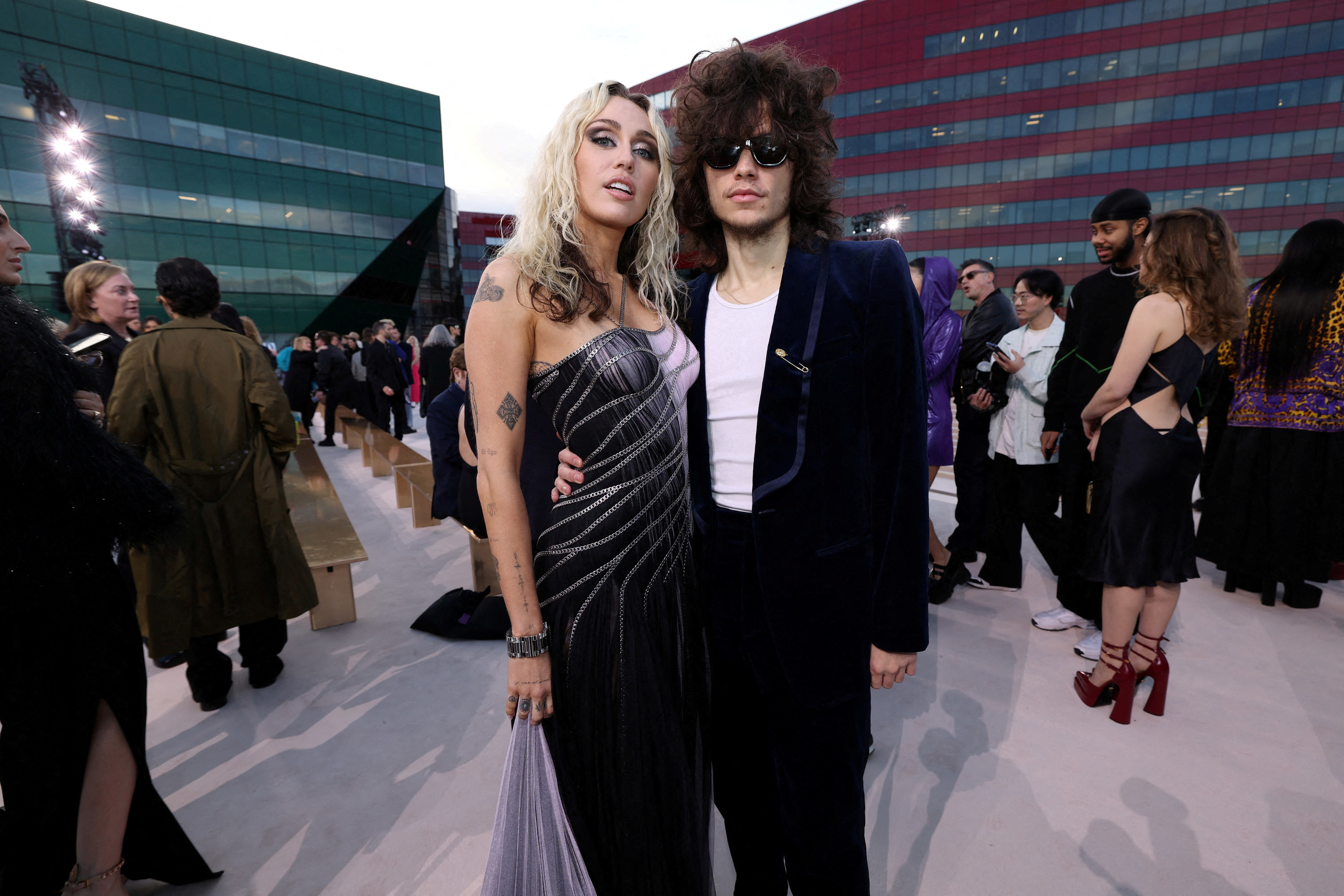 Miley Cyrus and Maxx Morando attend the Versace Fall-Winter 2023 collection fashion show