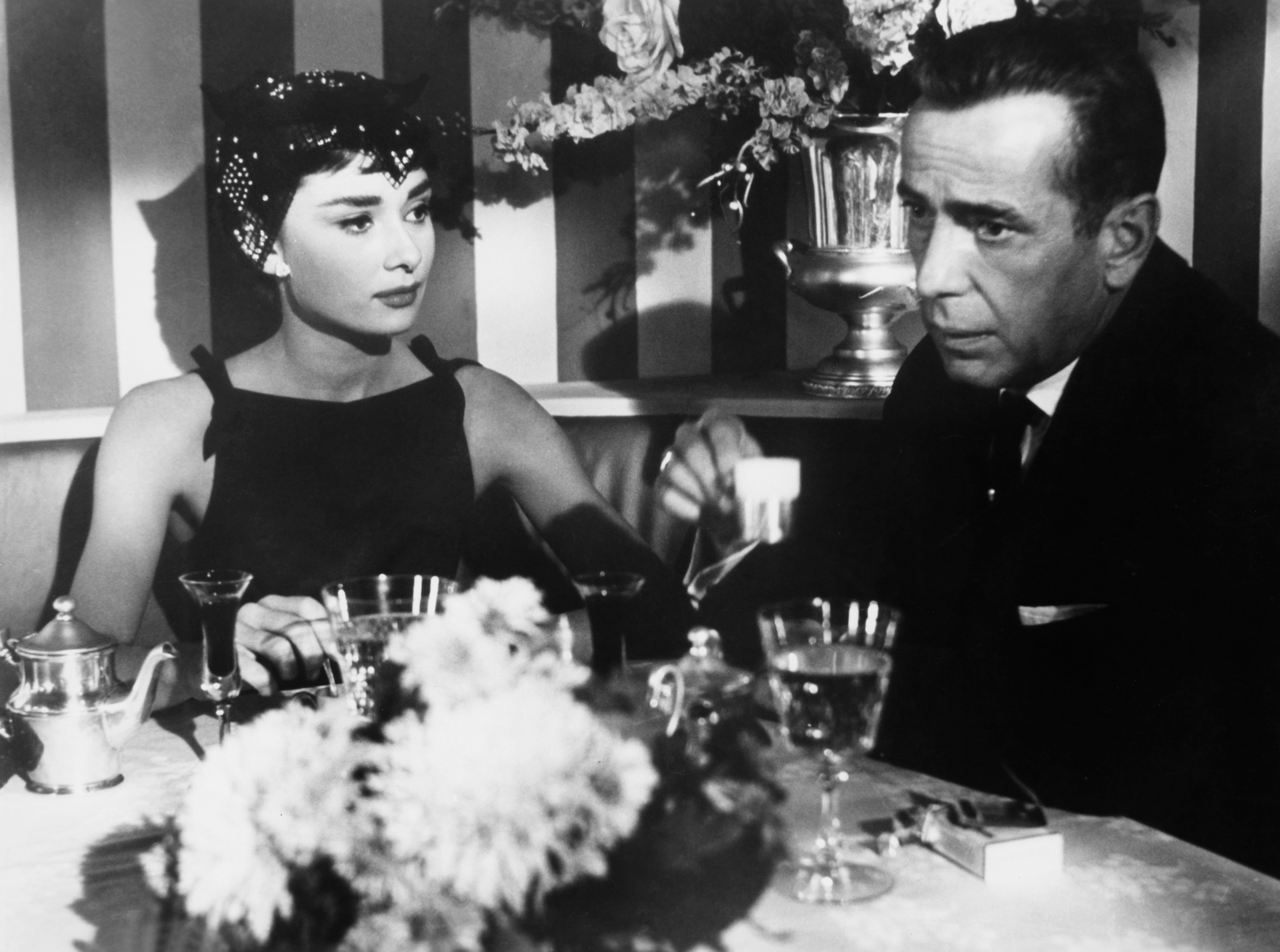 Audrey Hepburn and Humphrey Bogart eating a fancy dinner in Sabrina