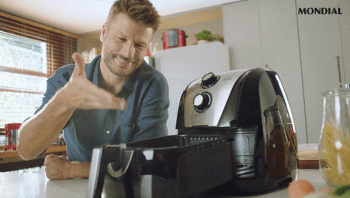 A man showing off his air fryer