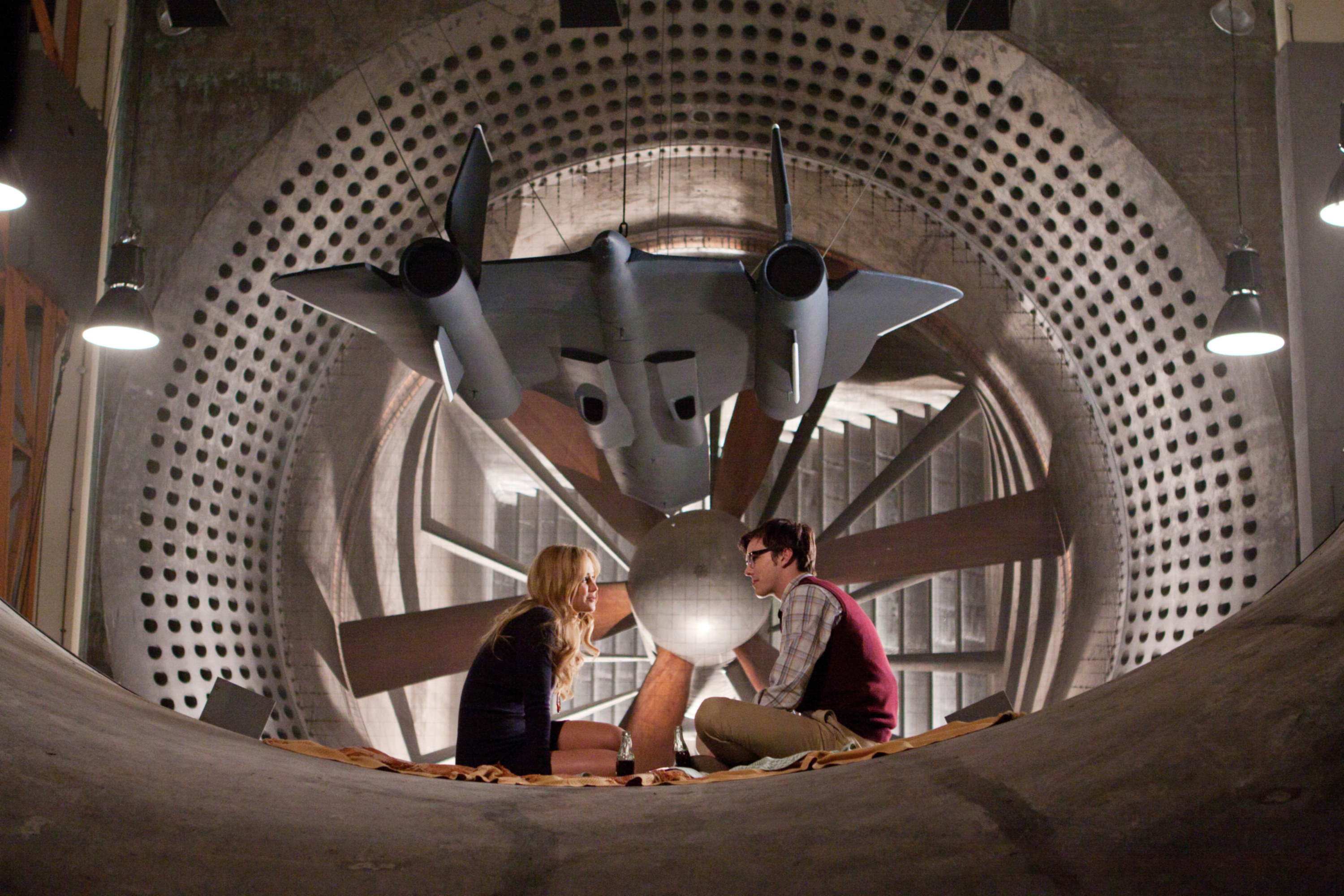 Jennifer Lawrence and Nicholas Hoult sharing a moment in an empty hanger in X-Men: First Class