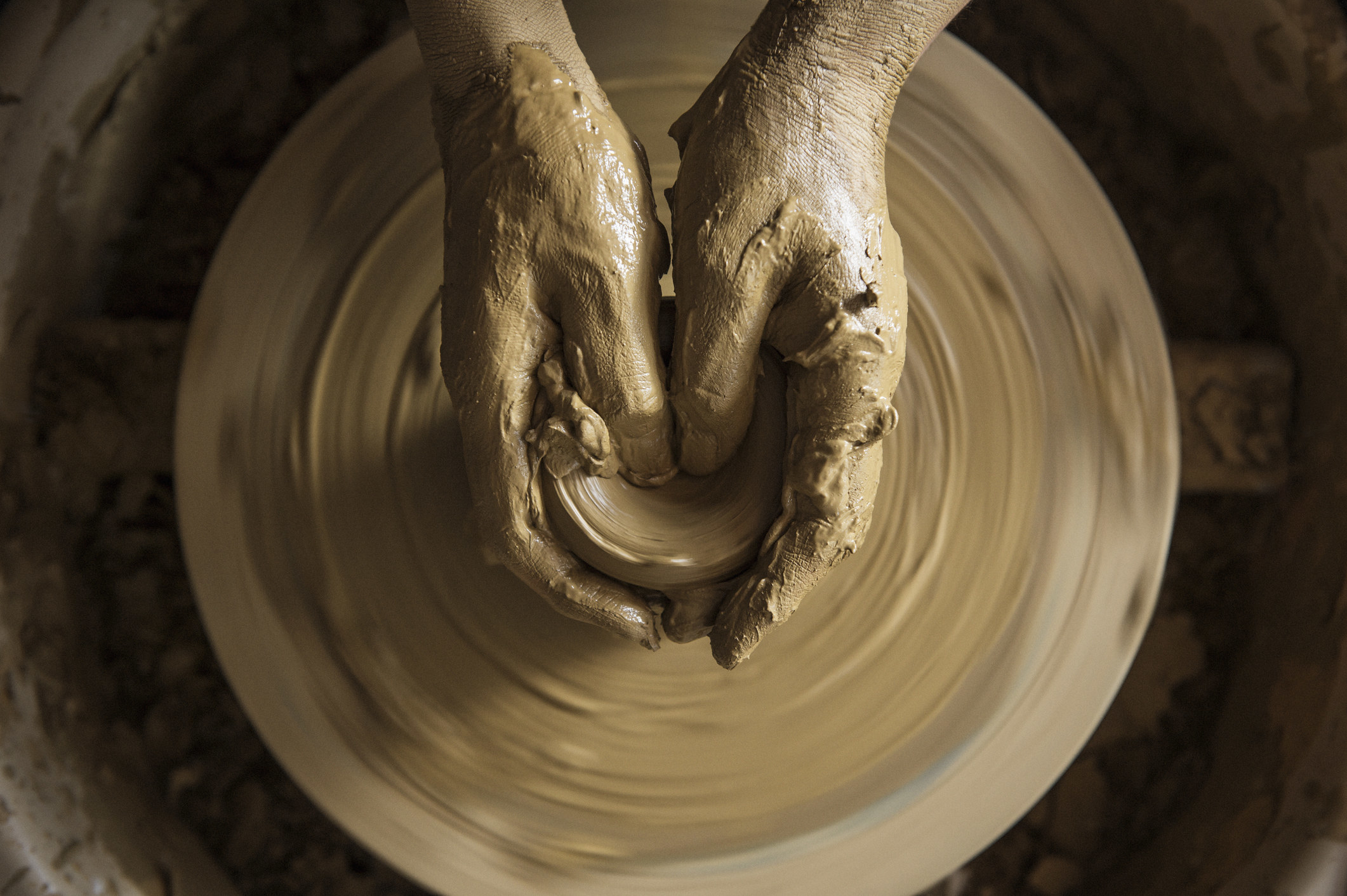 A woman using a pottery wheel.
